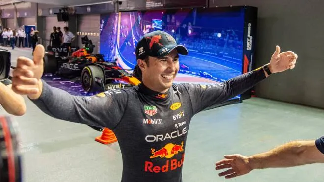 epa10219727 Mexican Formula One driver Sergio Perez of Red Bull Racing reacts after winning the Singapore Formula One Grand Prix race at the Marina Bay Street Circuit, Singapore, 02 October 2022.  EPA/TOM WHITE