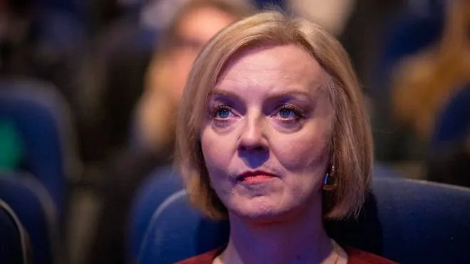 epa10219853 British Prime Minister Liz Truss listens the tributes to Britain's late Queen Elizabeth II at the opening session of Conservative Party Conference in Birmingham, Britain, 02 October 2022.  Prime Minister Liz Truss admitted they were flaws with the announcement of her 'mini-budget' which led to market turmoils and British pound going historic low against the US dollar.  EPA/TOLGA AKMEN