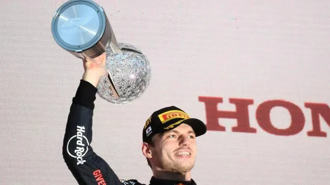 Red Bull Racing's Dutch driver Max Verstappen poses on the podium with the trophy following his victory at the Formula One Japanese Grand Prix at Suzuka, Mie prefecture on October 9, 2022. (Photo by Toshifumi KITAMURA / AFP)