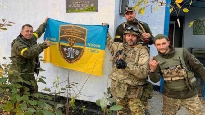 Militari ucraini espongono la bandiera nazionale nelle strade di Kherson