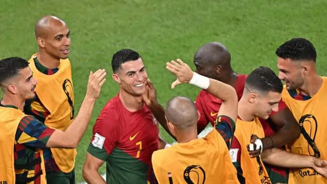 epa10325602 Cristiano Ronaldo (C) of Portugal celebrates scoring the opening goal from the penalty spot during the FIFA World Cup 2022 group H soccer match between Portugal and Ghana at Stadium 947 in Doha, Qatar, 24 November 2022.  EPA/Noushad Thekkayil