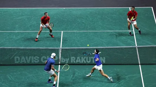 Italy�s Fabio Fognini (Down R) and Italy�s Matteo Berrettini return the ball to Canada�s Felix Auger-Aliassime (Top R) and Canada�s Vasek Pospisil during the men's double semi-final tennis of the Davis Cup tennis tournament match between Italy and Canada at the Martin Carpena sportshall, in Malaga on November 26, 2022. (Photo by Thomas COEX / AFP)