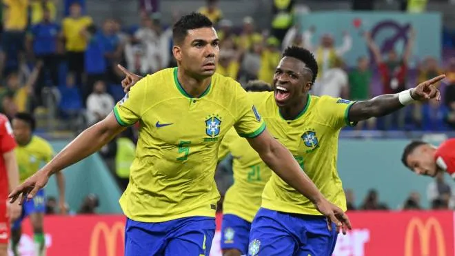 Brazil's midfielder #05 Casemiro (L) celebrates with Brazil's forward #20 Vinicius Junior after he scored his team's first goal during the Qatar 2022 World Cup Group G football match between Brazil and Switzerland at Stadium 974 in Doha on November 28, 2022. (Photo by NELSON ALMEIDA / AFP)