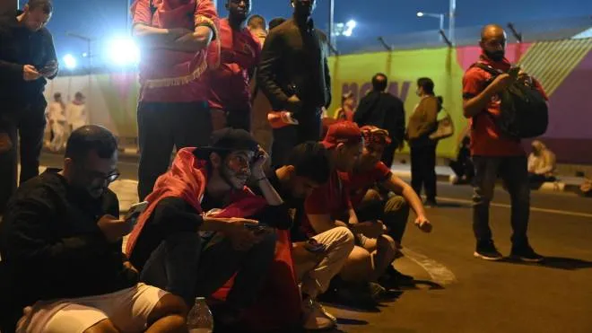 epa10359441 Morrocco supporters sit outside the Al Thumama Stadium during the FIFA World Cup 2022 quarter final soccer match between Morocco and Portugal, Qatar, 10 December 2022.  EPA/NEIL HALL