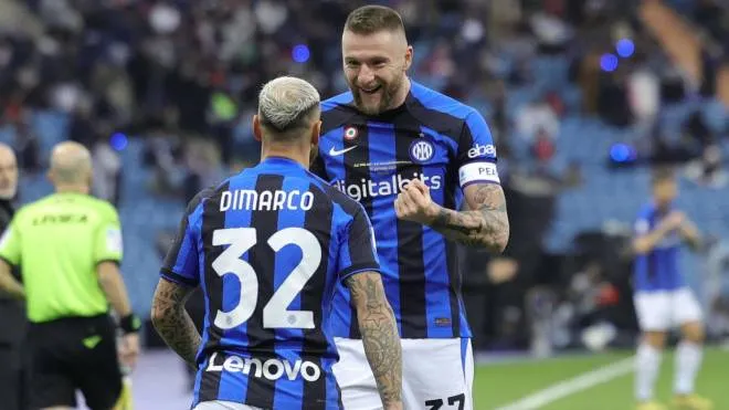 Inter Milan's Italian defender Federico Dimarco (L) celebrates scoring the first goal with Inter Milan's Slovakian defender Milan Skriniar during the Italian SuperCup football match between AC Milan and Inter Milan, at the King Fahd International Stadium in Riyadh on January 18, 2023. (Photo by Fayez Nureldine / AFP)