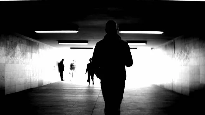 Silhouettes of people in the tunnel.
