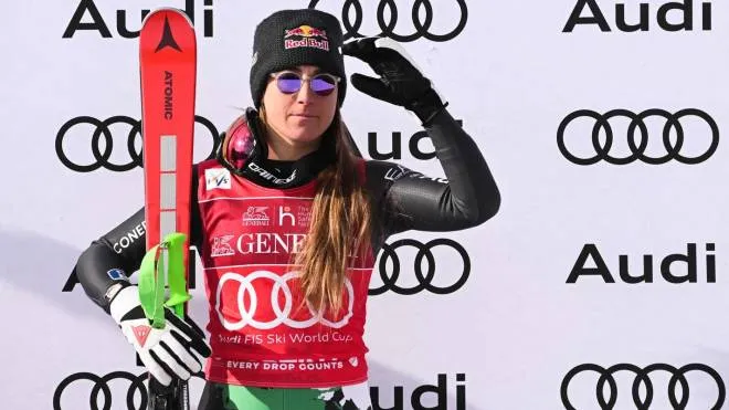 Italy's Sofia Goggia celebrates on the podiuam after winning the Women's Downhill as part of the FIS Alpine World Ski Championships in Cortina d'Ampezzo, Italian Alps, on January 20, 2023. (Photo by Tiziana FABI / AFP)