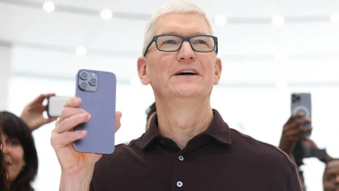 CUPERTINO, CALIFORNIA - SEPTEMBER 07: Apple CEO Tim Cook looks at a new iPhone 14 Pro during an Apple special event on September 07, 2022 in Cupertino, California. Apple unveiled the new iPhone 14 as well as new versions of the Apple Watch, including the Apple Watch SE, a low-cost version of the popular timepiece that will start at $249.   Justin Sullivan/Getty Images/AFP (Photo by JUSTIN SULLIVAN / GETTY IMAGES NORTH AMERICA / Getty Images via AFP)