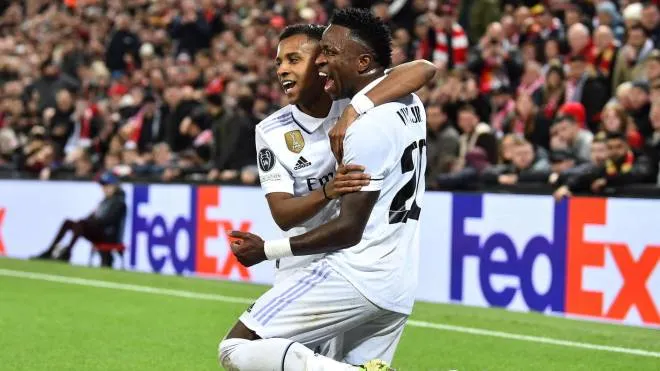 epaselect epa10482482 Vinicius Junior (R) of Real Madrid celebrates with teammate Rodrygo after scoring his second goal during the UEFA Champions League, Round of 16, 1st leg match between Liverpool FC and Real Madrid in Liverpool, Britain, 21 February 2023.  EPA/Peter Powell