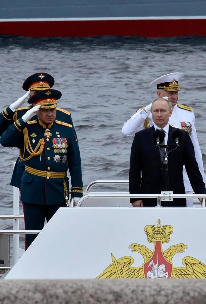 Sopra: Putin passa in rassegna la navi da combattimento. In alto: un’esercitazione