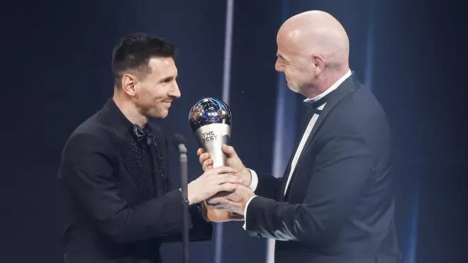 epa10494453 Argentinian soccer player Lionel Messi of Paris Saint-Germain FC receives his the Best FIFA Men's Player Award from FIFA President Gianni Infantino on stage during the The Best FIFA Football Awards 2022 ceremony in Paris, France, 27 February 2023.  EPA/YOAN VALAT