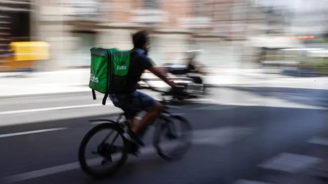 A delivery rider on his way to deliver an order in Madrid, Spain, 10 August 2021. ANSA/JUAN CARLOS HIDALGO