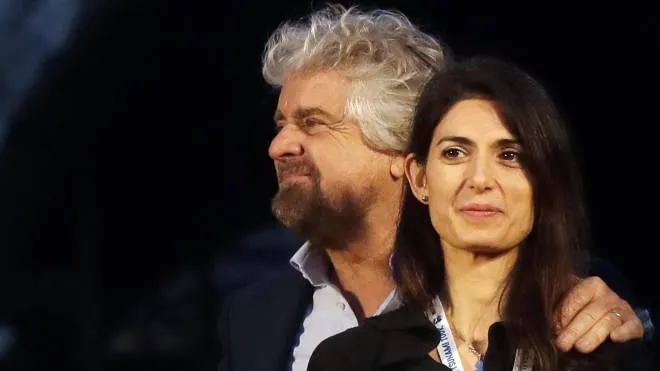In this photo taken Saturday, Nov 26, 2016, Rome Mayor Virginia Raggi and 5-Star Movement leader Beppe Grillo attend a political rally in Rome. Raggi vowed Friday to continue her administration following the arrest in a corruption probe of a top City Hall official that dealt another blow to the populist 5-Star Movement's highest profile office holder. (ANSA/AP Photo/Gregorio Borgia) [CopyrightNotice: Copyright 2016 The Associated Press. All rights reserved.]