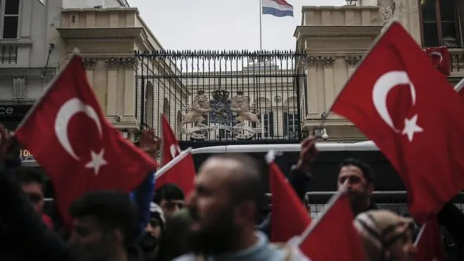 A group of Turks protest outside the Dutch consulate in Istanbul, Sunday, March 12, 2017. Turkish President Recep Tayyip Erdogan says he appropriately accused the Dutch government of "Nazism and fascism," saying only those types of regimes would bar foreign ministers from traveling within their countries. Erdogan also said during a live televised address on Sunday that the Netherlands would "pay the price" for sacrificing its ties with a NATO ally to upcoming elections there. (ANSA/AP Photo/ Emrah Gurel) [CopyrightNotice: Copyright 2017 The Associated Press. All rights reserved.]