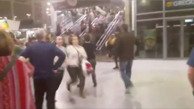 People running down stairs as they attempt to exit the Manchester Arena after a blast, where U.S. singer Ariana Grande had been performing, in Manchester, Britain in this still image taken from video May 22, 2017. @ZACH_BRUCE/ via REUTERS TV ATTENTION EDITORS - BROADCASTERS: MUST COURTESY @ZACH_BRUCE WITH NO ARCHIVAL USE AND NO RESALE. DIGITAL: MUST COURTESY @ZACH_BRUCE WITH NO ARCHIVAL USE AND NO RESALE. FOR REUTERS CUSTOMERS ONLY. FOR EDITORIAL USE ONLY. NO RESALES. NO ARCHIVES. THIS IMAGE HAS BEEN SUPPLIED BY A THIRD PARTY. MANDATORY CREDIT. NO THIRD PARTY SALES. NOT FOR USE BY REUTERS THIRD PARTY DISTRIBUTORS.      TPX IMAGES OF THE DAY