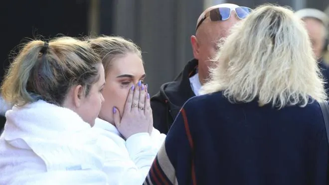 Fan leaves the Park Inn hotel in central Manchester, England, Tuesday, May 23, 2017. Over a dozen people were killed in an explosion following a Ariana Grande concert at the Manchester Arena late Monday evening. (ANSA/AP Photo/Rui Vieira) [CopyrightNotice: Copyright 2017 The Associated Press. All rights reserved.]