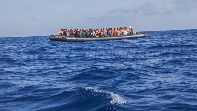 A rubber boat with 129 migrants on board, among them 60 women, is seen sailing out of control about 15 miles north of Al Khums, Libya, on Tuesday, Aug. 1, 2017. The Spanish NGO Proactiva Open Arms rescue ship 'Golfo Azzurro' rescued about 500 migrants and recovered 8 bodies Tuesday. (ANSA/AP Photo/Anna Surinyach) [CopyrightNotice: Copyright 2017 The Associated Press. All rights reserved.]