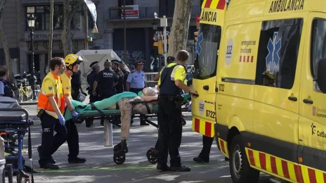 epa06148681 Mossos d'Esquadra Police officers and emergency service workers move an injured after a van crashes into pedestrians in Las Ramblas, downtown Barcelona, Spain, 17 August 2017. According to initial reports a van crashed into a crowd in Barcelona's famous Placa Catalunya square at Las Ramblas area injuring several. Local media report the van driver ran away, metro and train stations were closed. The number of people injured and the reasons behind the incident are not yet known. Official sources have not confirmed that the incident is a terrorist attack.  EPA/Quique Garcia FACES PIXELATED BY SOURCE DUE TO LOCAL LAW