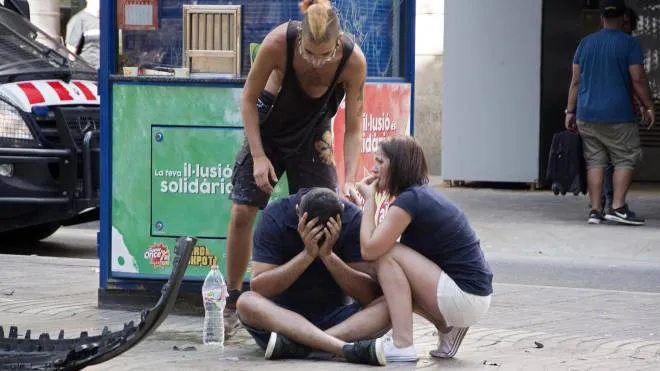 epa06148638 Injured people react after a van crashed into pedestrians in Las Ramblas, downtown Barcelona, Spain, 17 August 2017. According to initial reports a van crashed into a crowd in Barcelona's famous Placa Catalunya square at Las Ramblas area injuring several. Local media report the van driver ran away, metro and train stations were closed. The number of people injured and the reasons behind the incident are not yet known. Official sources have not confirmed that the incident is a terrorist attack.  EPA/David Armengou