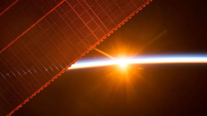 This NASA handout image obtained August 1, 2017 shows what a member of the Expedition 52 crew aboard the International Space Station captured in this photograph of one of the 16 sunrises they experience every day, as the orbiting laboratory travels around Earth on July 26, 2017. 
One of the solar panels that provides power to the station is seen in the upper left.The station's solar arrays produce more power than it needs at one time for station systems and experiments. When the station is in sunlight, about 60 percent of the electricity that the solar arrays generate is used to charge the station's batteries. The batteries power the station when it is not in the Sun.
 / AFP PHOTO / NASA / Handout / RESTRICTED TO EDITORIAL USE - MANDATORY CREDIT "AFP PHOTO /NASA/HANDOUT" - NO MARKETING NO ADVERTISING CAMPAIGNS - DISTRIBUTED AS A SERVICE TO CLIENTS