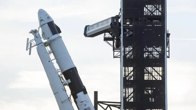 A SpaceX Falcon 9 rocket with the company's Crew Dragon spacecraft onboard is seen as it is raised into a vertical position on the launch pad at Launch Complex 39A as preparations continue for the Demo-1 mission, Thursday, Feb. 28, 2019 at the Kennedy Space Center in Florida. The Demo-1 mission will be the first launch of a commercially built and operated American spacecraft and space system designed for humans as part of NASA's Commercial Crew Program. The mission, currently targeted for a 2:49am launch on March 2, will serve as an end-to-end test of the system's capabilities. (Joel Kowsky/NASA via AP) [CopyrightNotice: (NASA/Joel Kowsky) For copyright and restrictions refer to - http://www.nasa.gov/audience/formedia/features/MP_Photo_Guidelin]