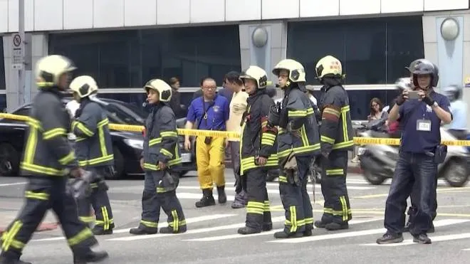 In this image made from a video, firefighters gather on a street in Taipei, Taiwan following an earthquake  Thursday, April 18, 2019. A strong earthquake struck Taiwan's east coast Thursday afternoon, according to the island's Central Weather Bureau. (ANSA/AP Photo)