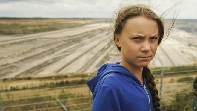 Climate activist Greta Thunberg stands in front of the open-cast lignite pit during a visit the ancient Hambach Forest near the city of Kerpen in western Germany, Aug. 10, 2019. The teenage activist who is a leading figure in the Fridays for Future strikes against climate said that seeing the open-cast lignite pit in Hambach disturbed her deeply and that the time has come to stop talking and take action. (ANSA/AP Photos/Mstyslav Chernov) [CopyrightNotice: Copyright 2019 The Associated Press. All rights reserved.]