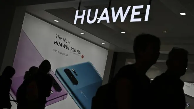 Visitors walk past the booth of Huawei promoting its P30 Pro smartphone at the international electronics and innovation fair IFA in Berlin on September 6, 2019. - Exhibitors from more than 100 countries will be presenting their latest products during the fair running from September 6 to 11, 2019. (Photo by Tobias SCHWARZ / AFP)