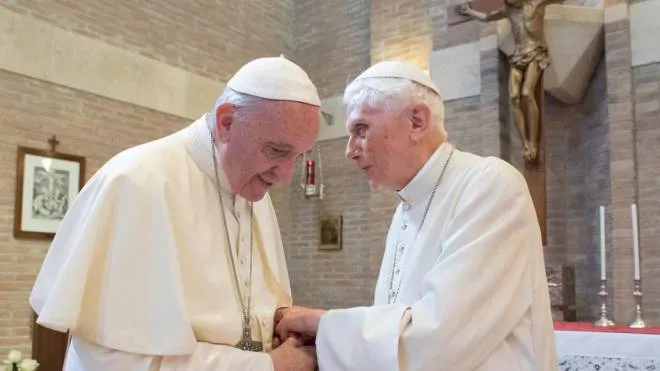 This handout picture released on February 15, 2018 by the Vatican press office shows Pope Francis (L) shaking hands with Pope Benedict XVI at the Vatican, on June 28, 2017. (Photo by HO / OSSERVATORE ROMANO / AFP) / RESTRICTED TO EDITORIAL USE - MANDATORY CREDIT "AFP PHOTO / OSSERVATORE ROMANO" - NO MARKETING NO ADVERTISING CAMPAIGNS - DISTRIBUTED AS A SERVICE TO CLIENTS
