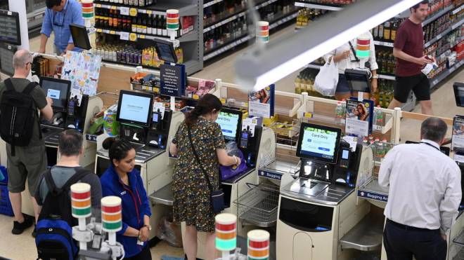 Acquirenti alle casse di un supermercato (Ansa)